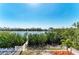 Waterfront views of the community, landscaping, and a private dock, creating a serene setting at 37 Bocilla Dr, Placida, FL 33946