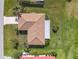 Aerial view of a well-manicured home with lush green lawn, mature palm trees, and a tile roof at 3871 Bordeaux Dr, Punta Gorda, FL 33950