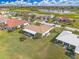 Aerial view of the rear of a home with a screened in patio, golf course, and pond nearby at 3871 Bordeaux Dr, Punta Gorda, FL 33950