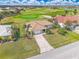 Aerial view of a home on a well manicured lot, with a golf course and pond nearby at 3871 Bordeaux Dr, Punta Gorda, FL 33950