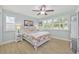 Cozy bedroom with a ceiling fan, shuttered windows, and nautical themed decor create a relaxing space at 3871 Bordeaux Dr, Punta Gorda, FL 33950