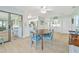 Cozy dining room featuring light blue walls, wood-look tile, and views of the kitchen and screened-in porch at 3871 Bordeaux Dr, Punta Gorda, FL 33950