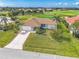 Beautiful single-story home with a tile roof, lush landscaping, and a view of the golf course at 3871 Bordeaux Dr, Punta Gorda, FL 33950