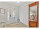 Well-lit foyer with tile floors, a coat closet, and a decorative mirror at 3871 Bordeaux Dr, Punta Gorda, FL 33950