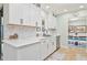 Well-lit kitchen featuring white cabinetry, stainless steel appliances, and stylish backsplash at 3871 Bordeaux Dr, Punta Gorda, FL 33950