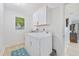 Bright laundry room with white cabinetry, full size washer and dryer, and tiled floor at 3871 Bordeaux Dr, Punta Gorda, FL 33950