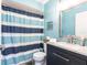 Bathroom with blue walls and striped shower curtain at 4000 Bal Harbor Blvd # 225, Punta Gorda, FL 33950