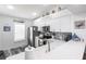 White kitchen with stainless steel appliances and breakfast bar at 4000 Bal Harbor Blvd # 225, Punta Gorda, FL 33950