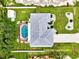 An aerial view showcasing a home's roofline, pool, and yard at 4059 Twinbush Ter, North Port, FL 34286