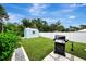 Landscaped backyard with grill and shed at 4059 Twinbush Ter, North Port, FL 34286