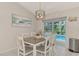 Bright dining area with table and chairs, view of pool at 4059 Twinbush Ter, North Port, FL 34286