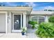 Front entrance featuring a decorative screen door and landscaping at 4059 Twinbush Ter, North Port, FL 34286