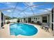 Relaxing screened-in pool area with patio furniture at 4059 Twinbush Ter, North Port, FL 34286