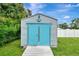 Exterior shed with light blue doors and nautical decor at 4059 Twinbush Ter, North Port, FL 34286