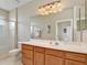 Bathroom with double vanity, large mirror and shower at 4149 Cascade Falls Dr, Sarasota, FL 34243