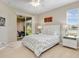 Bright bedroom with sliding glass doors leading to a patio and water view at 4149 Cascade Falls Dr, Sarasota, FL 34243