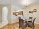 Charming dining area with glass table and wicker chairs, adjacent to kitchen at 4149 Cascade Falls Dr, Sarasota, FL 34243