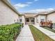 Side entrance with walkway, landscaping and AC units at 4149 Cascade Falls Dr, Sarasota, FL 34243