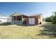 Spacious backyard featuring a screened porch, a storage shed, and a lush lawn at 4355 Boggs St, Port Charlotte, FL 33948