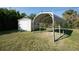 A well-maintained backyard featuring a utility shed and a metal carport frame at 4355 Boggs St, Port Charlotte, FL 33948