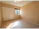 Bright bedroom featuring tile flooring, a ceiling fan, and a closet with sliding doors at 4355 Boggs St, Port Charlotte, FL 33948