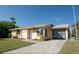 Charming single-story home with attached garage and well-manicured front lawn at 4355 Boggs St, Port Charlotte, FL 33948