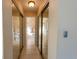 Hallway featuring closet with mirrored doors and view of adjacent bathrooms at 4355 Boggs St, Port Charlotte, FL 33948