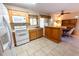 Efficient kitchen layout featuring tiled floors, modern appliances, and a breakfast bar at 4355 Boggs St, Port Charlotte, FL 33948