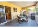 View of covered patio with a table and chairs, grill and view of backyard at 4355 Boggs St, Port Charlotte, FL 33948