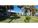 Lush backyard features a shed, canal access, and mature palm trees at 4542 Fallon Cir, Port Charlotte, FL 33948