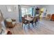 Dining area with hardwood floors, modern table and six chairs with blue themed decorations and furniture at 4542 Fallon Cir, Port Charlotte, FL 33948