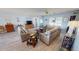 Cozy living room with a blue color scheme, modern furniture, hardwood floors, and plenty of natural light at 4542 Fallon Cir, Port Charlotte, FL 33948