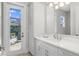 Clean bathroom with a vanity and door to backyard at 500 Blue Shell Loop, Sarasota, FL 34240