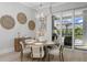 Bright dining room with pool and outdoor kitchen views; seating for six at 500 Blue Shell Loop, Sarasota, FL 34240