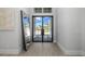 Light and airy entryway with modern black framed double doors at 500 Blue Shell Loop, Sarasota, FL 34240