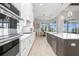 Modern kitchen with white cabinets and stainless steel appliances, overlooking water at 500 Blue Shell Loop, Sarasota, FL 34240