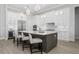 Modern kitchen with white cabinetry, large island, and stainless steel appliances at 500 Blue Shell Loop, Sarasota, FL 34240