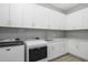 Modern laundry room with washer, dryer, and ample cabinet space at 500 Blue Shell Loop, Sarasota, FL 34240