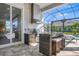 Modern outdoor kitchen with stainless steel appliances and a glass-top island at 500 Blue Shell Loop, Sarasota, FL 34240