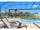 Inviting pool area with lounge chairs and a screened enclosure at 500 Blue Shell Loop, Sarasota, FL 34240