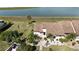 Aerial view of villa with landscaped yard and a view of the lake at 5688 Mashie Cir, North Port, FL 34287