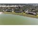 Scenic aerial view of homes in a lakeside community with mature trees and ample green space at 5688 Mashie Cir, North Port, FL 34287