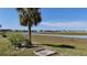 Lush backyard view with a scenic canal beyond at 5688 Mashie Cir, North Port, FL 34287