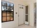 Bright foyer with white tiled flooring and access to the bathroom at 5688 Mashie Cir, North Port, FL 34287