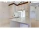 Kitchen with white cabinets and a pass-through window to the dining area at 5688 Mashie Cir, North Port, FL 34287