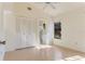 Sunlit main bedroom featuring a ceiling fan, closet, and en-suite bathroom at 5688 Mashie Cir, North Port, FL 34287