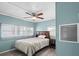 Relaxing bedroom with a ceiling fan and natural light at 6835 Anapa Ct, North Port, FL 34287