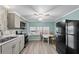 Bright kitchen area with modern appliances and table with four chairs near window at 6835 Anapa Ct, North Port, FL 34287