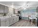 Updated kitchen featuring gray cabinets, modern appliances, and an adjacent dining area at 6835 Anapa Ct, North Port, FL 34287