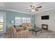 Inviting living room with comfortable seating, a ceiling fan, and lots of natural light at 6835 Anapa Ct, North Port, FL 34287